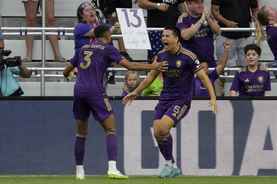Orlando City's Cesar Araujo (5) celebrates his goal against Toronto FC with Rafael Santos (3) during the first half of an MLS soccer match Tuesday, July 4, 2023, in Orlando, Fla. (AP Photo/John Raoux)