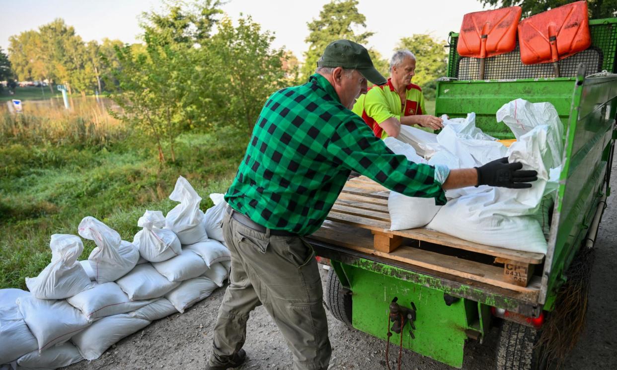 <span>Workers at Wrocław zoo, close to the Oder River, build flood reinforcements on Wednesday.</span><span>Photograph: Maciej Kulczyński/EPA</span>