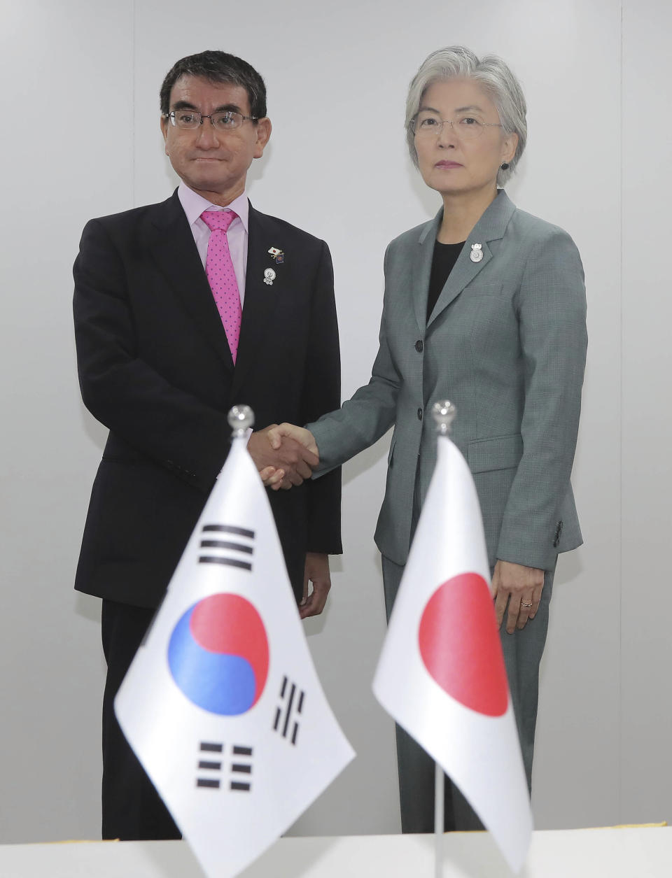 Japanese Foreign Minister Taro Kono, left, and his South Korean counterpart Kang Kyung-wha pose for a photo prior to a bilateral meeting on the sidelines of the ASEAN Foreign Ministers Meetings in Bangkok, Thailand, Thursday, Aug. 1, 2019. (Lee Jung-hoon/Yonhap via AP)