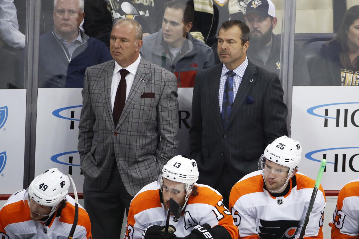 FILE - Philadelphia Flyers assistant Michel Therrien, left, and head coach Alain Vigneault stand behind their bench during the first period of an NHL hockey game against the Pittsburgh Penguins in Pittsburgh, Oct. 29, 2019. The Philadelphia Flyers have fired coach Alain Vigneault following eight straight losses, two shy of matching a team record of 10 in a row, a person with knowledge of the situation told The Associated Press on Monday, Dec. 6, 2021. (AP Photo/Gene J. Puskar, File)