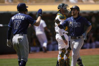 Tampa Bay Rays second baseman Brandon Lowe, right, high-fives teammate Austin Meadows (17) after hitting a two-run home run off Oakland Athletics starting pitcher Frankie Montas during the sixth inning of a baseball game Saturday, May 8, 2021, in Oakland, Calif. (AP Photo/Tony Avelar)