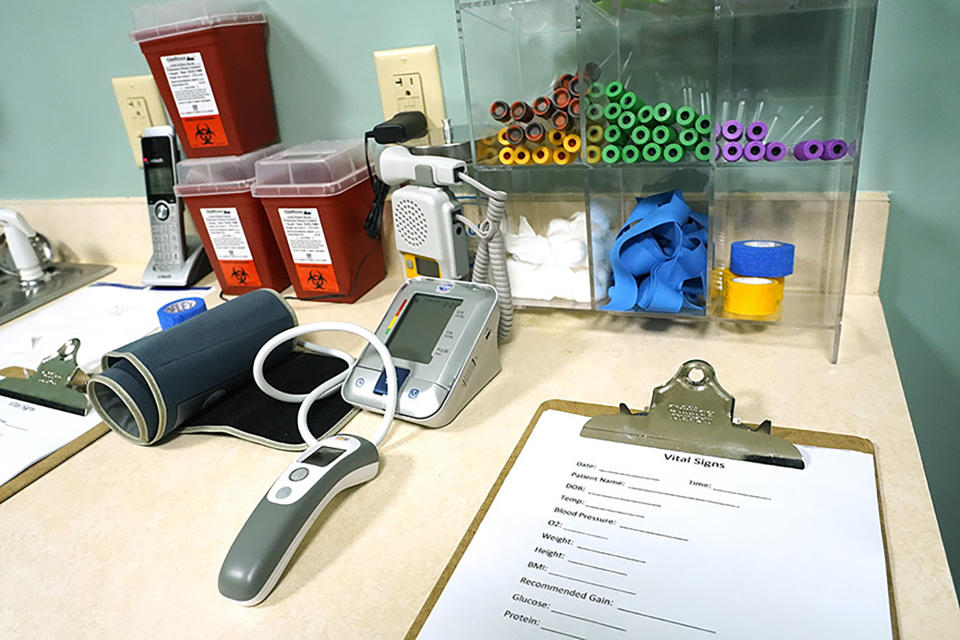 Blood collection tubes, a vital signs chart and a variety of monitors are readied for use with the patients at Sisters in Birth, a Jackson, Miss., clinic that serves pregnant women by utilizing an integrative and holistic approach to women's health care, Dec. 17, 2021. (AP Photo/Rogelio V. Solis)