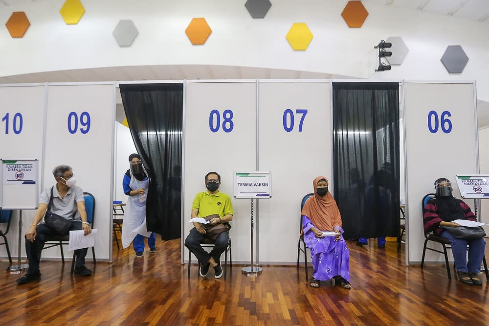 People wait to receive their Covid-19 vaccine jab at the mega vaccination centre located at UiTM in Puncak Alam June 7, 2021. — Picture by Yusof Mat Isa