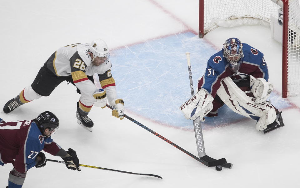 Colorado Avalanche goalie Philipp Grubauer (31) stops Vegas Golden Knights' Paul Stastny (26) during the first period of an NHL Stanley Cup qualifying round game in Edmonton, Alberta, Saturday, Aug. 8, 2020. (Jason Franson/The Canadian Press via AP)