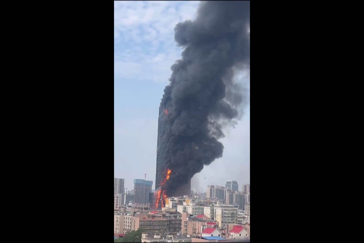 This screengrab taken from a video provided to AFPTV by an anonymous source on 16 September 2022 shows thick smoke billowing from a skyscraper in Changsha, Hunan  (ANONYMOUS/AFP via Getty Images)