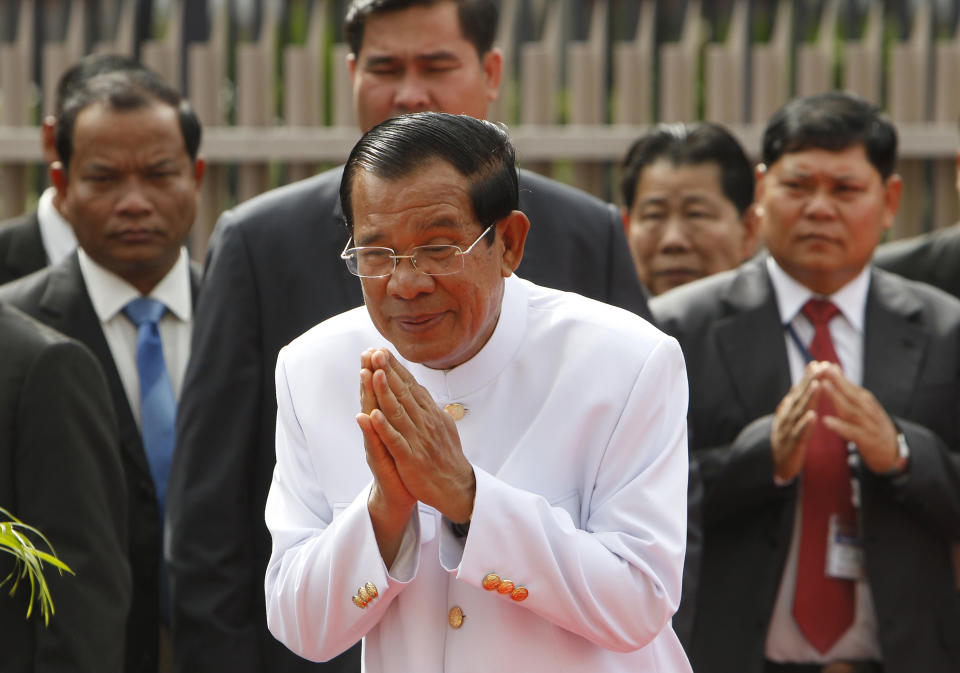 Cambodia's Prime Minister Hun Sen, center, sees King Norodom Sihamoni off in front of the National Assembly in Phnom Penh, Cambodia, Wednesday, Sept. 5, 2018. Cambodia National Assembly on Wednesday opening its the first session presided over by King Norodom Sihamoni to ensure long-ruling Prime Minister Hun Sen another term after his party swept election in late July. (AP Photo/Heng Sinith)