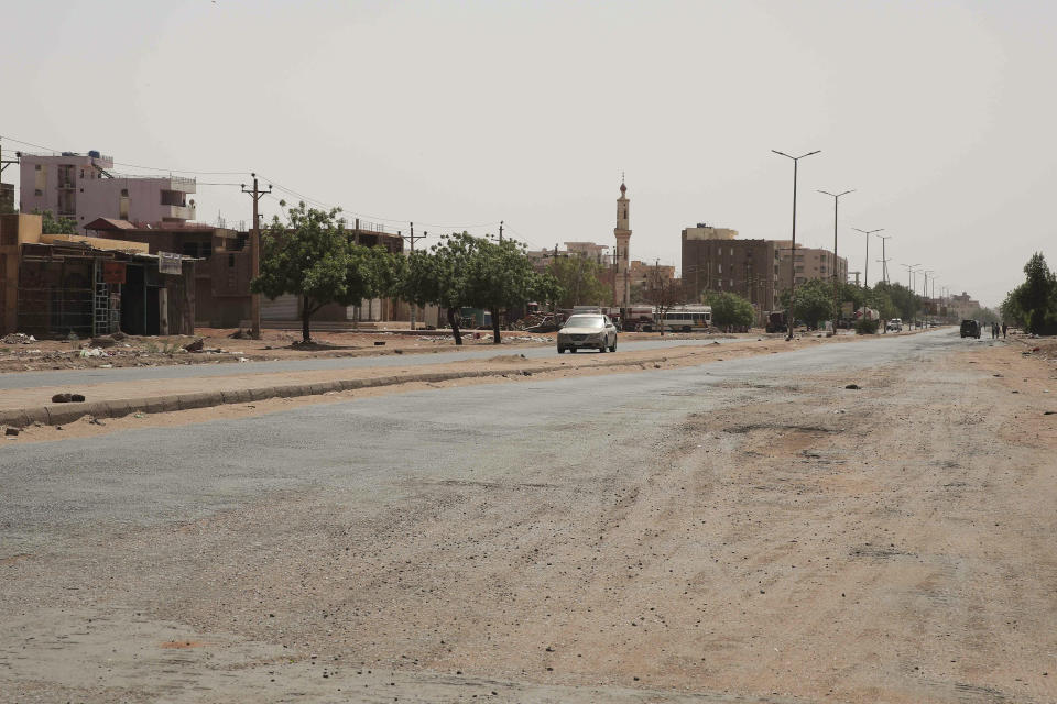 A vehicle crosses an empty street in Khartoum, Sudan, Saturday, April 29, 2023, as gunfire and heavy artillery fire continued despite the extension of a cease-fire between the country's two top generals. The battle for power between the country's army and its rival paramilitary has killed hundreds and sent thousands fleeing for their lives. (AP Photo/Marwan Ali)