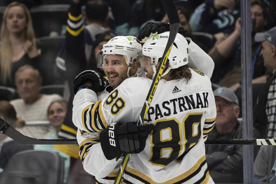 Boston Bruins defenseman Kevin Shattenkirk, left, and forward David Pastrnak (88) celebrate after a goal during the first period of an NHL hockey game against the Seattle Kraken, Monday, Feb. 26, 2024, in Seattle. (AP Photo/Stephen Brashear)