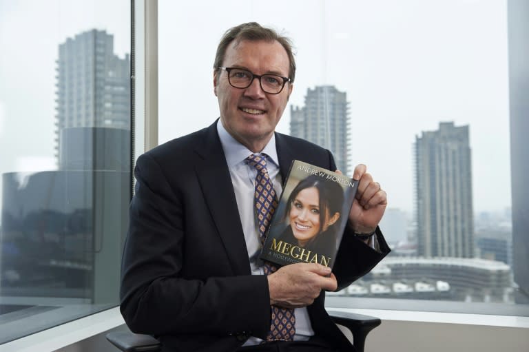 British journalist and writer Andrew Morton, pictured in April 2018, holds a copy of his biography of Meghan Markle