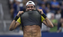 Matteo Berrettini, of Italy, bites his shirt after defeating Andrey Rublev, of Russia, during the fourth round of the US Open tennis championships Monday, Sept. 2, 2019, in New York. (AP Photo/Sarah Stier)