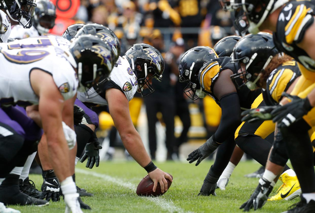 Baltimore Ravens center Tyler Linderbaum prepares to snap the ball against the Pittsburgh Steelers.