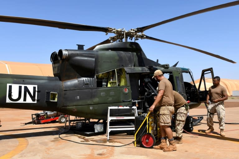 Canadian UN peacekeeping soldiers work on an helicopter at the Castors Camp in Gao, Mali