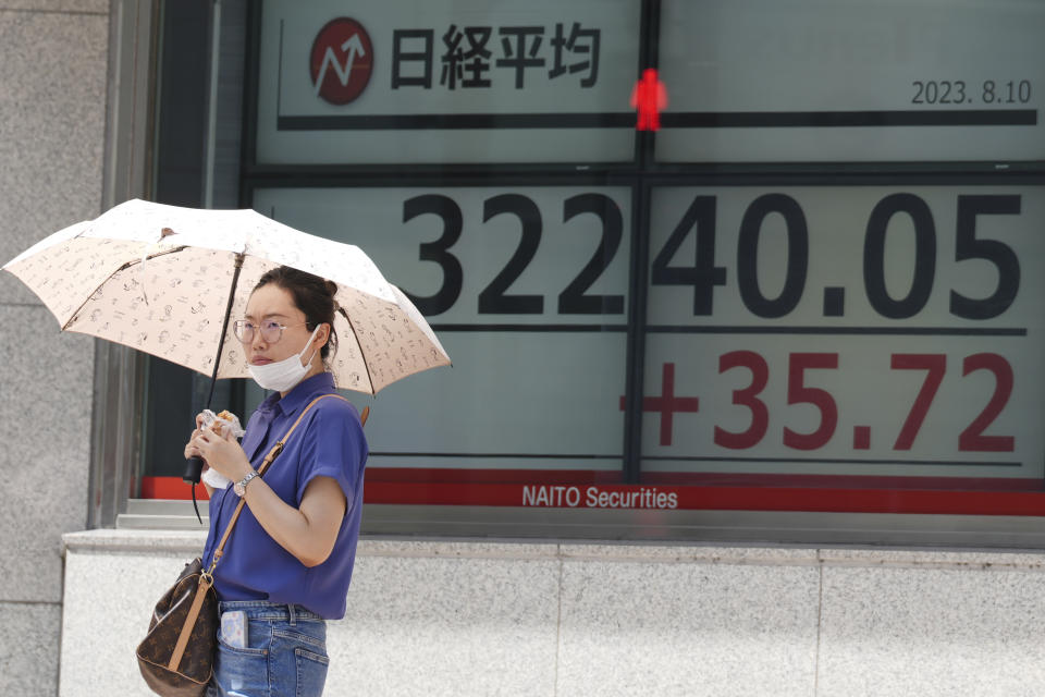 A person stands in front of an electronic stock board showing Japan's Nikkei 225 index at a securities firm Thursday, Aug. 10, 2023, in Tokyo. Asian benchmarks mostly fell Thursday after shares declined on Wall Street and investors braced for a highly anticipated report on U.S. inflation. (AP Photo/Eugene Hoshiko)