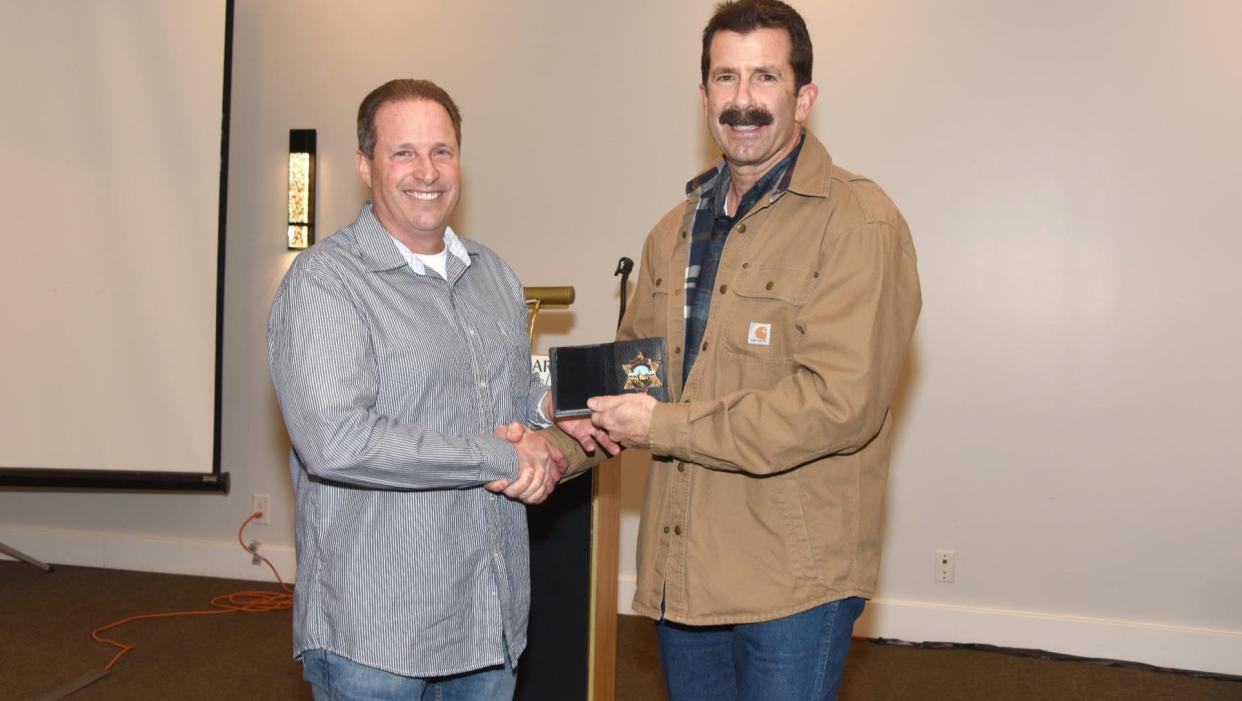 Bob Fleming, left, receives his retirement badge from former Ventura County Sheriff in Bill Ayub. Fleming, who worked for the sheriff's office for 32 years, recently drowned when a wave knocked him off a rocky outcrop and swept him into the waters off the island.