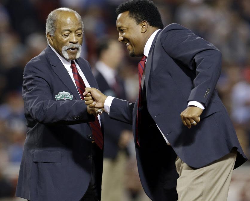 Luis Tiant (left) hangs out with Hall of Famer Pedro Martinez at Fenway Park in Boston. Tiant was inducted to the Red Sox Hall of Fame in 1997. (AP)