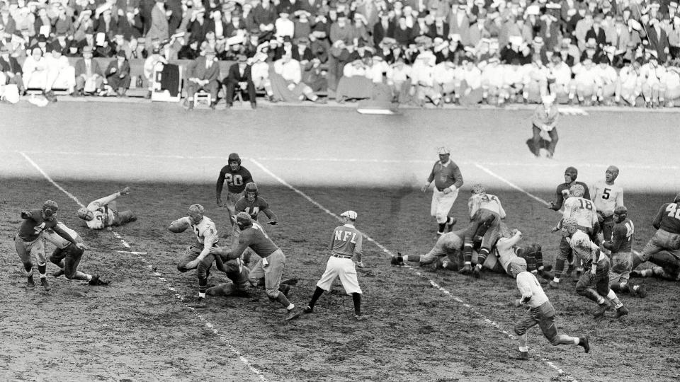 Mandatory Credit: Photo by AP/REX/Shutterstock (6032000b)Cecil Isbell Cecil Isbell (17), Green Bay halfback, hits the line for a ten-yard gain in the first quarter at the Polo Grounds as the New York Giants defeated the Green Bay Packers in their National Professional Football game in New YorkGiants Green Bay, New York, USA.