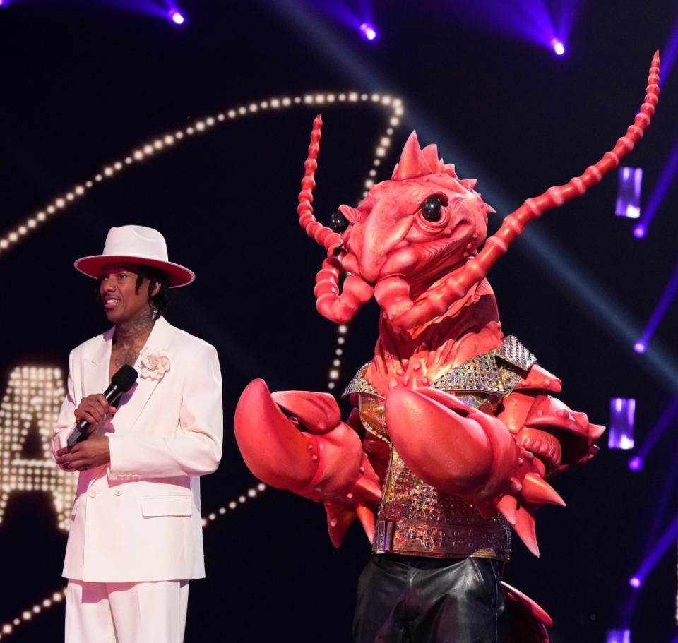 THE MASKED SINGER: L-R: Host Nick Cannon and Rock Lobster in the “ABBA Night” episode of THE MASKED SINGER airing Wednesday, Feb. 22 (8:00-9:01 PM ET/PT) on FOX. CR: Michael Becker/FOX ©2023 FOX Media LLC. C