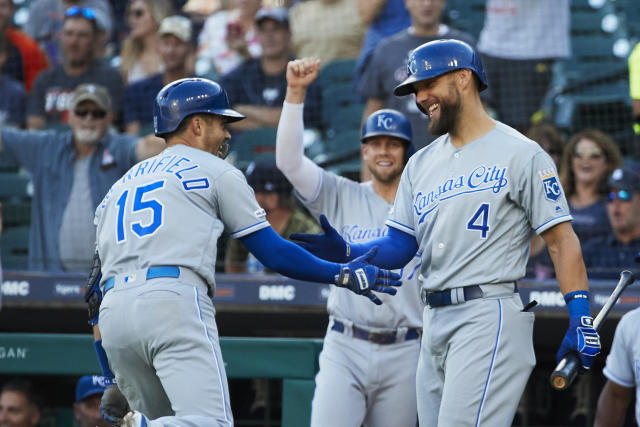 Kansas City Royals' Whit Merrifield, left, Alex Gordon, top right,  congratulate teammate Salvador Perez, middle, after his game-winning 2-RBI  double during the ninth inning of a baseball game against the Seattle  Mariners