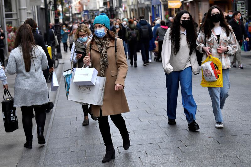 FILE PHOTO: People wear protective face masks while out for Christmas shopping in Dublin