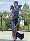 <p>dazzles in a high-slit, sequin-embellished Versace gown, Stuart Weitzman platforms and Cartier jewelry. </p>