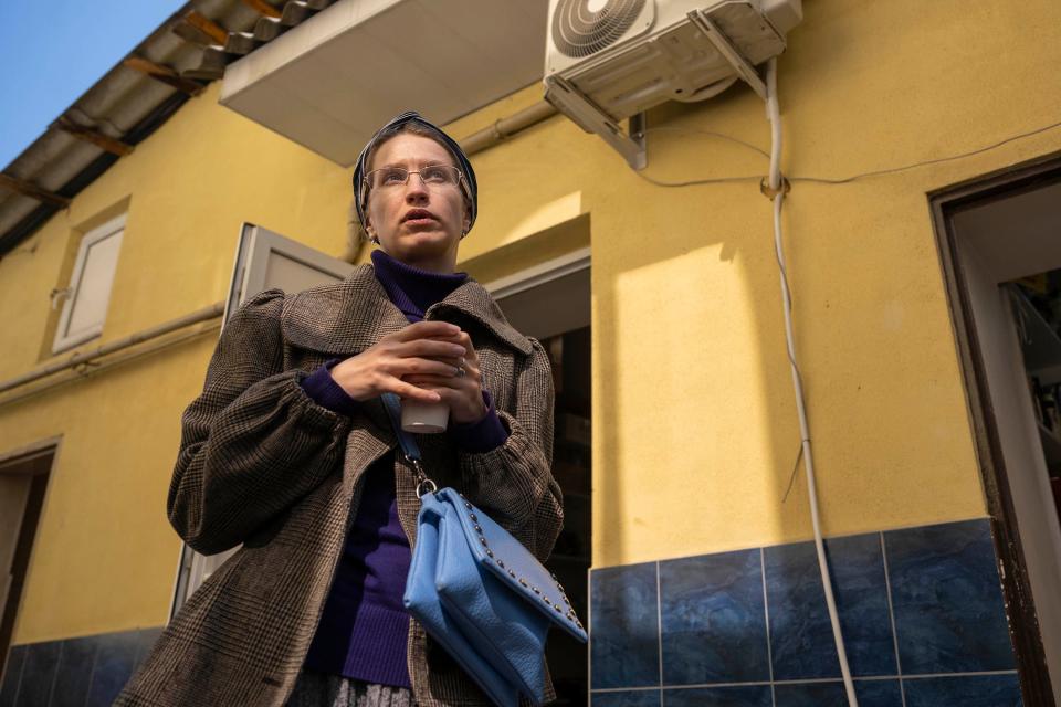 Olena Khorenjenko drinks a cup of tea outside the Synagogue Habad Lubavitch Kishinev, which is under renovation, in Chisinau, Moldova, on March 24.