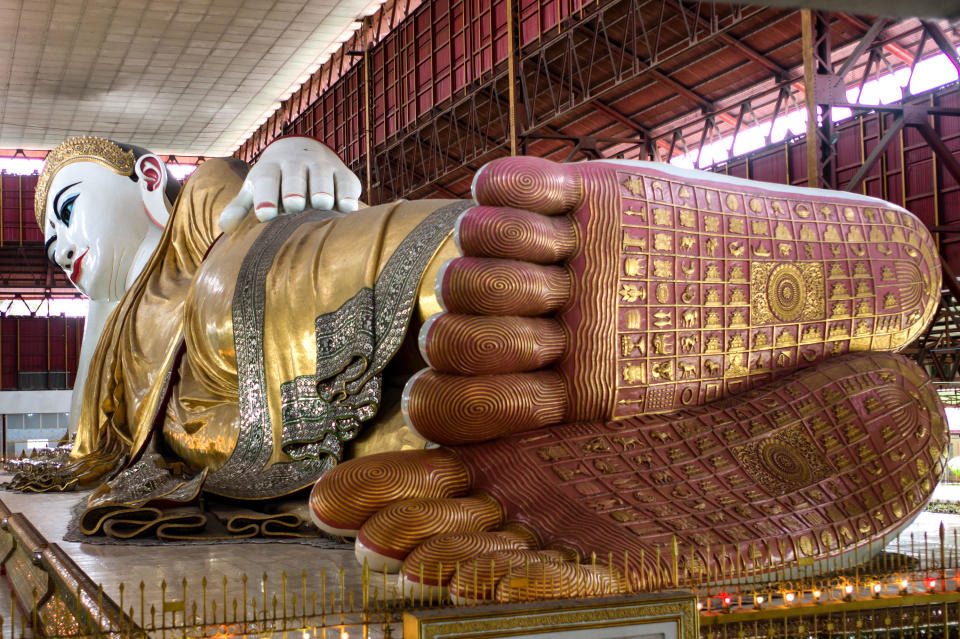 This December 2012 photo shows a reclining Buddha decorated in gold leaf at the Chaykhtatgyi Pagoda, in Mandalay, in Myanmar. (AP Photo/Richard Camp)