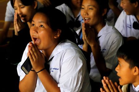 FILE PHOTO: Classmates pray after their teacher announced some of the 12 schoolboys trapped inside a flooded cave have been rescued, at Mae Sai Prasitsart school, in the northern province of Chiang Rai, Thailand July 9, 2018. REUTERS/Tyrone Siu/File Photo