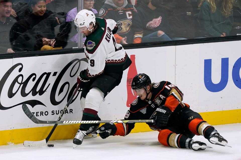 Anaheim Ducks right wing Troy Terry, right, reaches for the puck against Arizona Coyotes right wing Clayton Keller during overtime in an NHL hockey game Wednesday, Nov. 1, 2023, in Anaheim, Calif. (AP Photo/Ryan Sun)