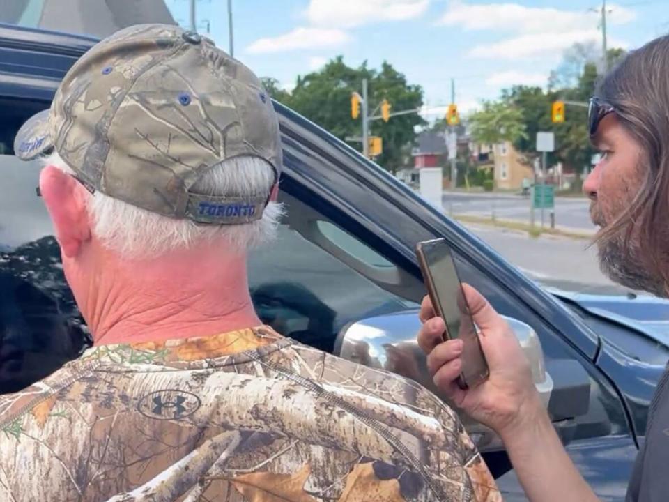 In this screengrab from a social media post, Frank Curtin and Timothy Claudio are seen confronting two Peterborough, Ont., police officers prior to their arrests on Saturday, Aug. 13. (Caryma Sa'd/Twitter - image credit)