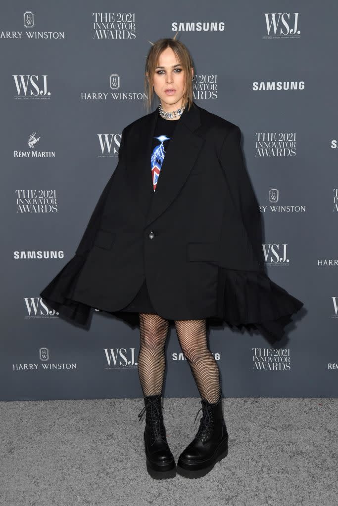 <p>Dorfman paired fishnet tights, lace-up boots and an oversized suit jacket to the event. </p>