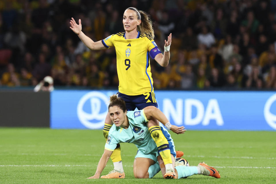 Sweden's Kosovare Asllani, top, reacts after a collision with Australia's Katrina Gorry during the Women's World Cup third place playoff soccer match between Australia and Sweden in Brisbane, Australia, Saturday, Aug. 19, 2023. (AP Photo/Tertius Pickard)