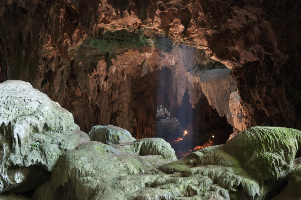 This undated photo provided by the Callao Cave Archaeology Project in April 2019 shows Callao Cave on Luzon Island of the Philippines, where the fossils of Homo luzonensis were discovered. This view is taken from the rear of the first chamber of the cave, where the fossils were found, in the direction of the second chamber. In a study released on Thursday, April 10, 2019, scientists report that tests on two samples from the species show minimum ages of 50,000 years and 67,000 years. (Callao Cave Archaeology Project via AP)