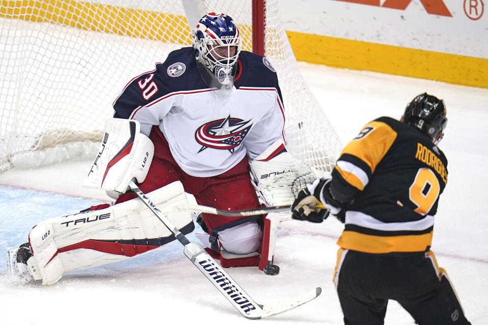 Pittsburgh Penguins' Evan Rodrigues (9) shoots past Columbus Blue Jackets goaltender J-F Berube (30) for a goal during the first period of an NHL hockey game in Pittsburgh, Friday, April 29, 2022. (AP Photo/Gene J. Puskar)