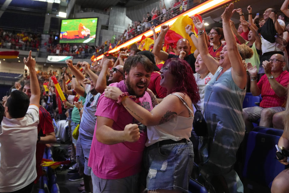Spanish fans celebrate Spain's victory as they watch the Women's World Cup final soccer match between Spain and England on a large screen, in Madrid, Spain, Sunday, Aug. 20, 2023. (AP Photo/Paul White)