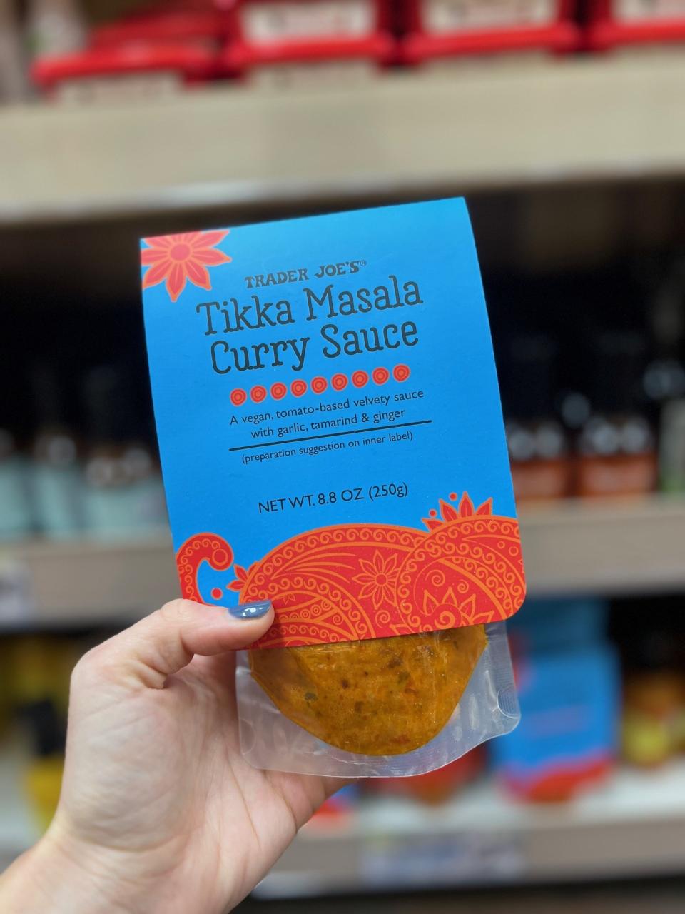 A package of Tikka Masala Curry Sauce: "a vegan, tomato-based velvety sauce with garlic, tamarind & ginger"