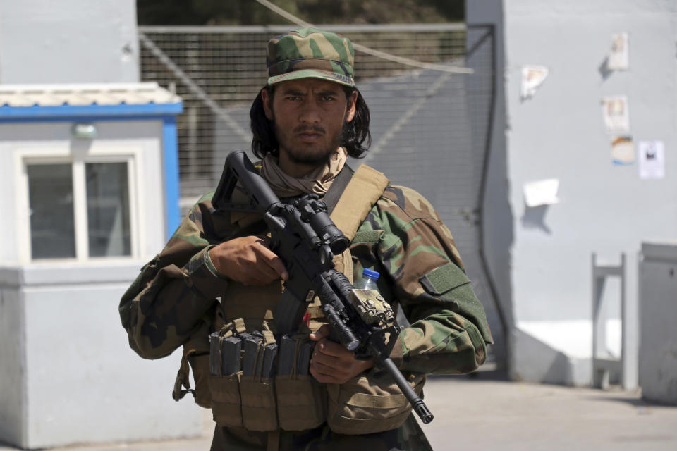A Taliban soldier stands guard at the gate of Hamid Karzai International Airport in Kabul, Afghanistan, Sunday, Sept. 5, 2021. Some domestic flights have resumed at Kabul's airport, with the state-run Ariana Afghan Airlines operating flights to three provinces. (AP Photo/Wali Sabawoon)