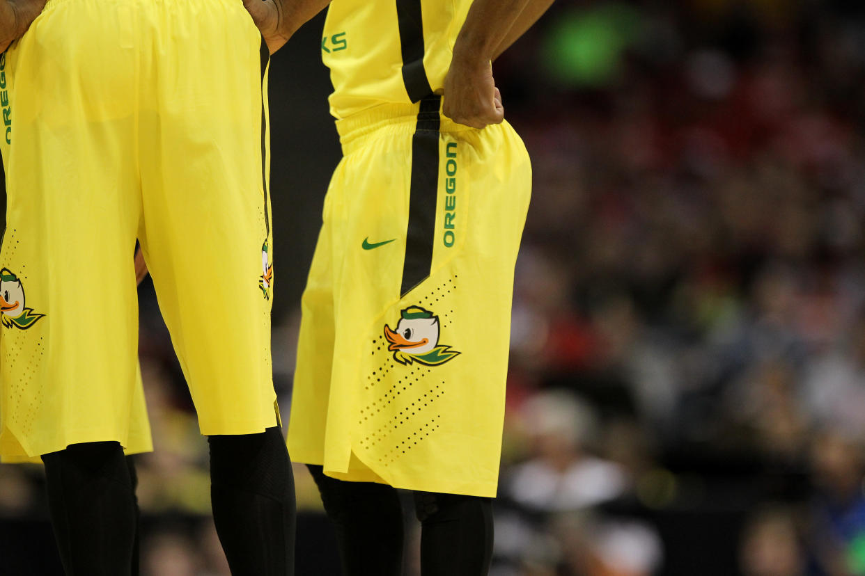 The Oregon Ducks in their signature Nike shoes and apparel during the first half of the game against the BYU Cougers in the second round of the 2014 NCAA Men's Basketball Tournament in Madison, Wisconsin.  (Photo by Mike McGinnis/Getty Images)