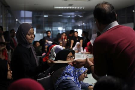 Employee receives termination letter from Utusan Malaysia management at the company's headquarters in Kuala Lumpur