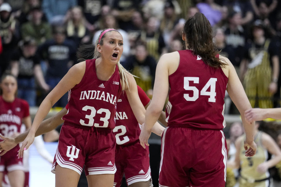 Indiana guard Sydney Parrish (33) celebrated with forward Mackenzie Holmes (54) as Purdue called a time out in the second half of an NCAA college basketball game in West Lafayette, Ind., Sunday, Feb. 5, 2023. Indiana defeated Purdue 69-46. (AP Photo/Michael Conroy)