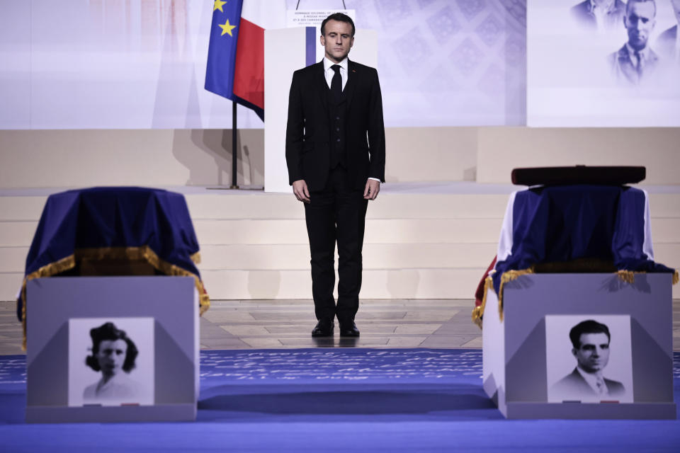 French President Emmanuel Macron pays his respects at the coffins of Missak Manouchian, and his wife Mélinée in the Pantheon monument during their induction ceremony, Wednesday, Feb 21, 2024 in Paris. While France hosts grandiose ceremonies commemorating D-Day, Missak Manouchian and his Resistance fighters' heroic role in World War II are often overlooked. A communist, poet who took refuge in France after surviving the Armenian genocide, Manouchian was executed in 1944 for leading the resistance to Nazi occupation. (Christophe Petit Tesson/Pool via AP)