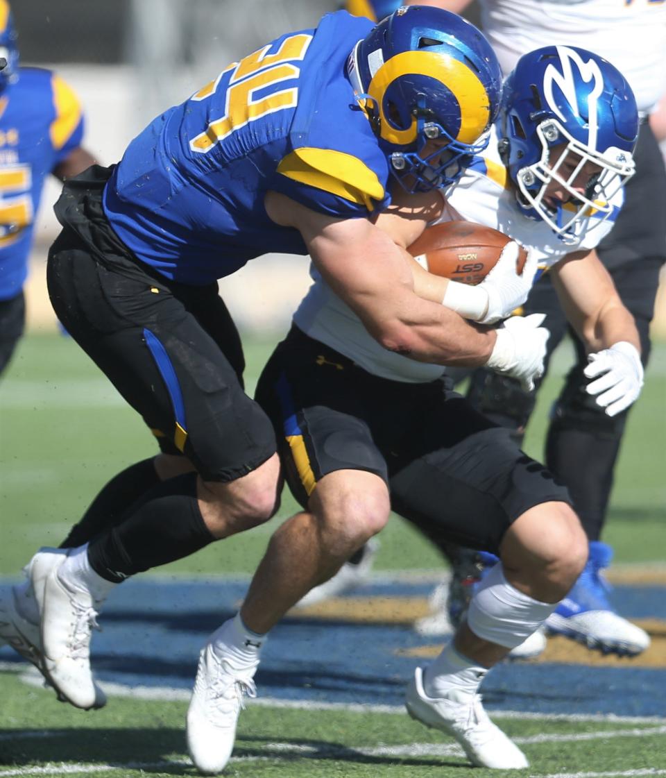 Angelo State University linebacker Hunter Kyle, left, makes a tackle during an NCAA Division II second-round playoff game against Nebraska-Kearney at LeGrand Stadium at 1st Community Credit Union Field on Saturday, Nov. 27, 2021.