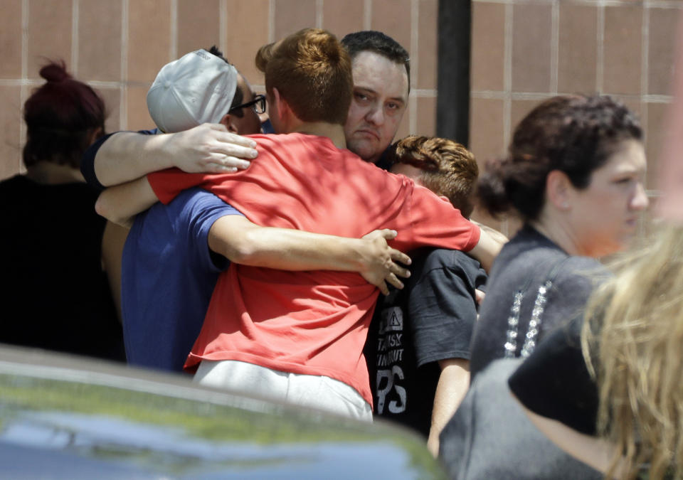 <p>People react outside the unification center at the Alamo Gym, following a shooting at Santa Fe High School Friday, May 18, 2018, in Santa Fe, Texas. (Photo: David J. Phillip/AP) </p>