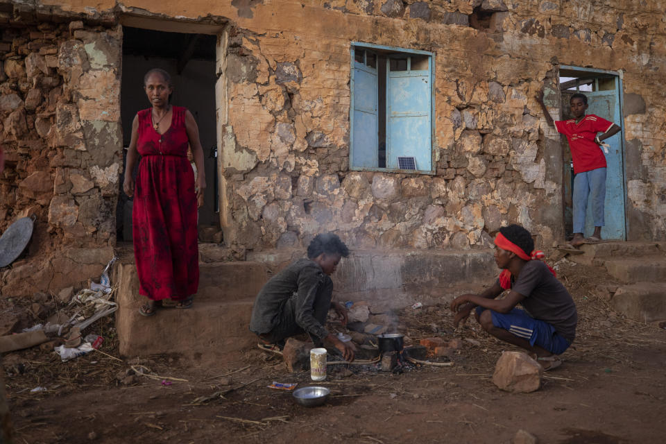 Tigrayans who fled the conflict in Ethiopia's Tigray region, start wood fires to prepare dinner, in front of their temporary shelters at Umm Rakouba refugee camp in Qadarif, eastern Sudan, Monday, Dec. 7, 2020. (AP Photo/Nariman El-Mofty)