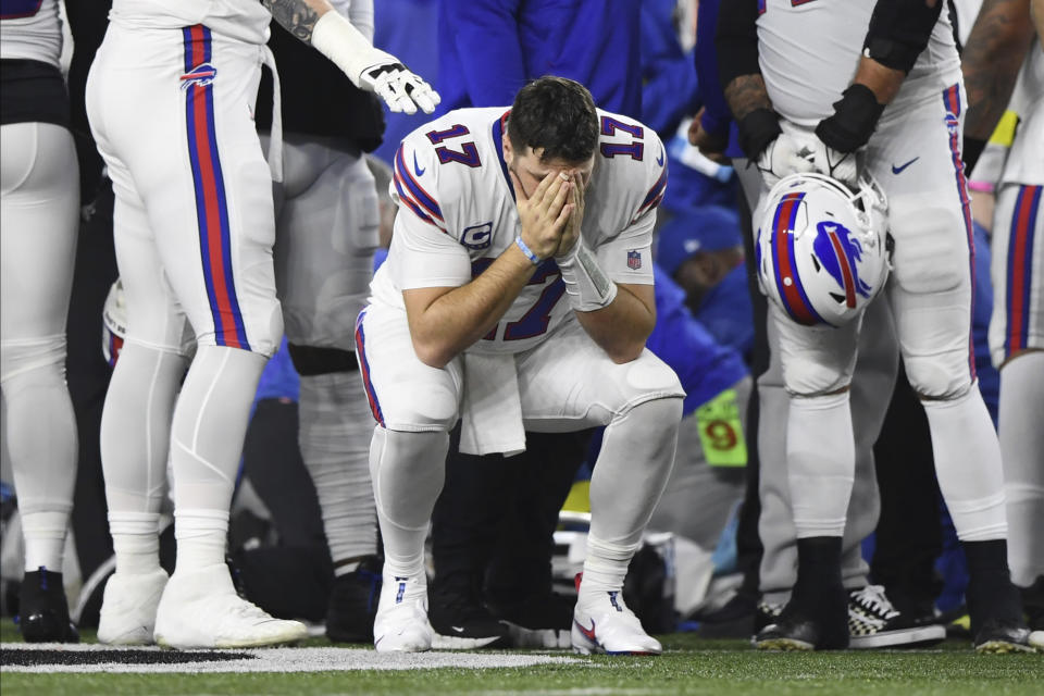 Buffalo Bills quarterback Josh Allen (17) pauses as Damar Hamlin is examined by medical staff during the first half of an NFL football game against the Cincinnati Bengals, Monday, Jan. 2, 2023, in Cincinnati. (AP Photo/Emilee Chinn)