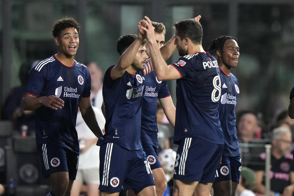 New England Revolution midfielder Carles Gil, center, is congratulated by midfielder Matt Polster (8) after scoring a goal against Inter Miami during the first half of an MLS soccer match Saturday, May 13, 2023, in Fort Lauderdale, Fla. (AP Photo/Lynne Sladky)
