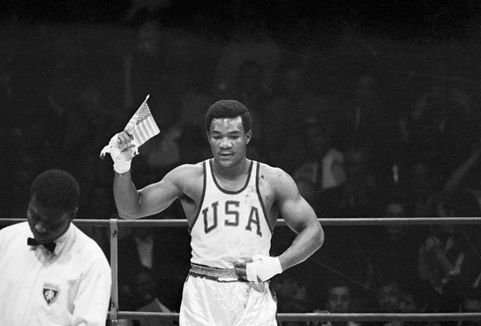 1968: George Foreman Waves American Flag