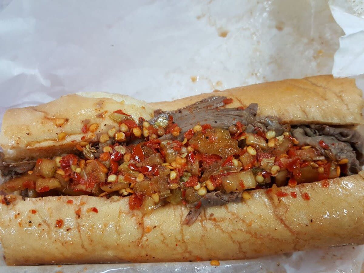 Closeup of Italian Beef Sandwich on white serving paper, Al's Italian Beef, Chicago, on the middle to bottom of image