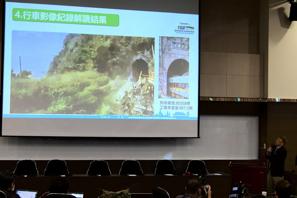 Yang Hong-chih, director of Taiwan Transportation Safety Board, at right, shows the dashboard footage recovered from the crushed wreckage of a train during a press conference held in Taipei in Taiwan on Tuesday, April 6, 2021. Investigators looking into Taiwan's deadliest railway disaster in decades combed through the crushed wreckage and debris for three days before they found the microSD chip from the dashboard camera of a construction truck that collided with a train coming out of a tunnel, officials said Tuesday. (AP Photo/Johnson Lai)