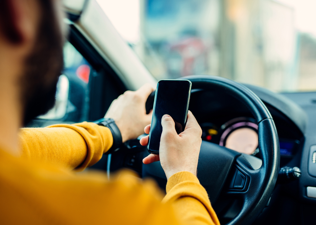 Man using mobile phone while driving.