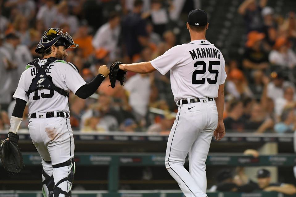 Detroit Tigers catcher Eric Haase, left, fist-bumps starting pitcher Matt Manning after the top of the fifth inning of the team's baseball game against the Toronto Blue Jays, Friday, Aug. 27, 2021, in Detroit.